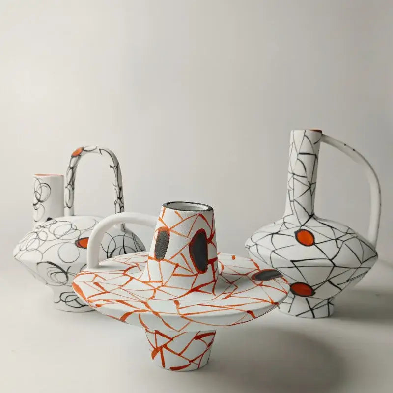 White ceramic vase with orange and black abstract crackle glaze from decorbites geometric line fringe decoration set