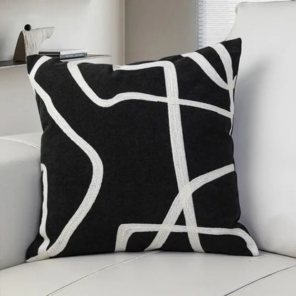 Black suede throw pillow with bold white geometric line embroidered design for living room decorbites geometric line