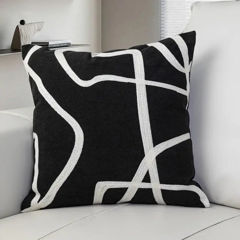Black suede throw pillow with bold white geometric line embroidered design for living room decorbites geometric line
