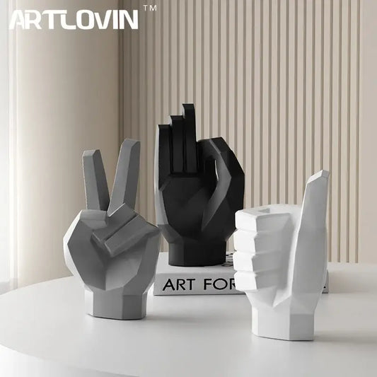 Set of three geometric hand gesture art decor sculptures in matte gray black and white resin for living room use
