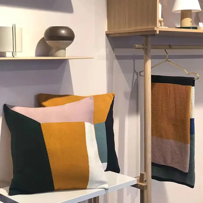 Geometric-patterned cushion with bold mustard yellow pink navy blue and white fabric for decorbites knitted chenille decor