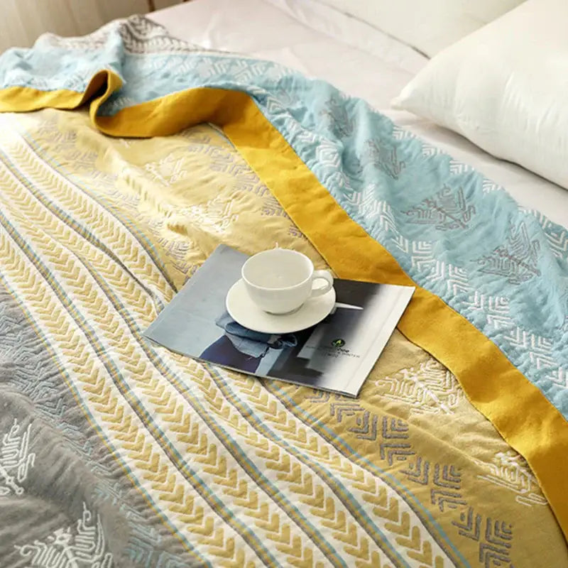 A soft quilted geometric mustard and gray cotton gauze summer blanket from decorbites cotton gauze collection