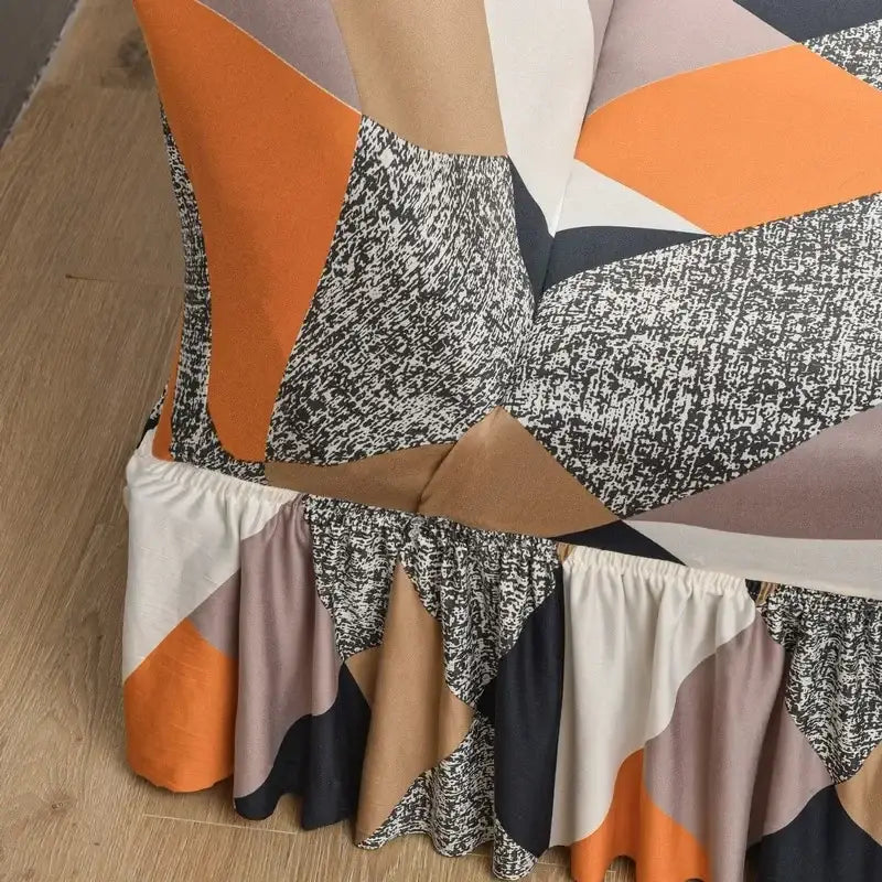 Geometric-patterned bed skirt with ruffled hem in orange black beige and gray tones for elastic armless futon sofa cover