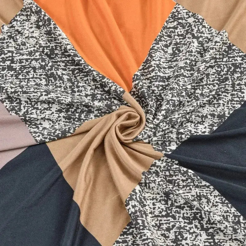 Geometric orange black elastic armless futon sofa cover with bold patchwork scarf design in solid and speckled patterns
