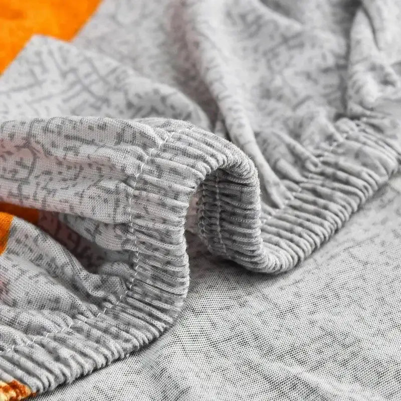 Gray heathered fabric with subtle pattern and elasticated waistband for decorbites colorful block sofa covers