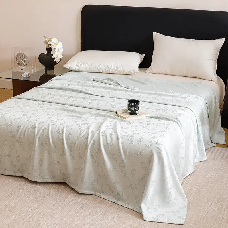 Light blue satin bedspread with silver floral embroidery complements geometric pink bamboo fiber summer lightweight bedding