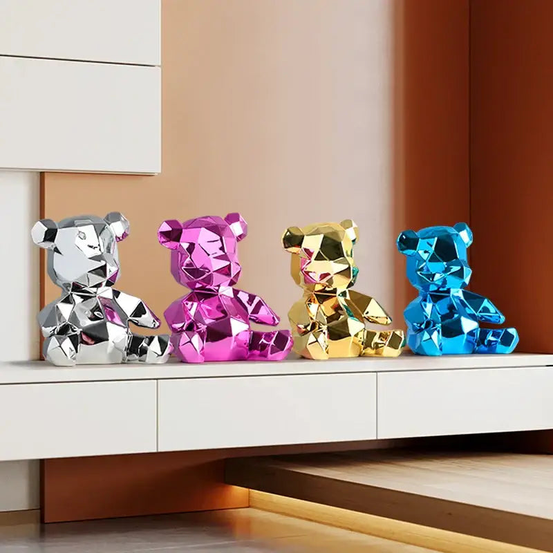 Four geometric electroplated teddy bear sculptures in silver pink gold and blue for living room decor