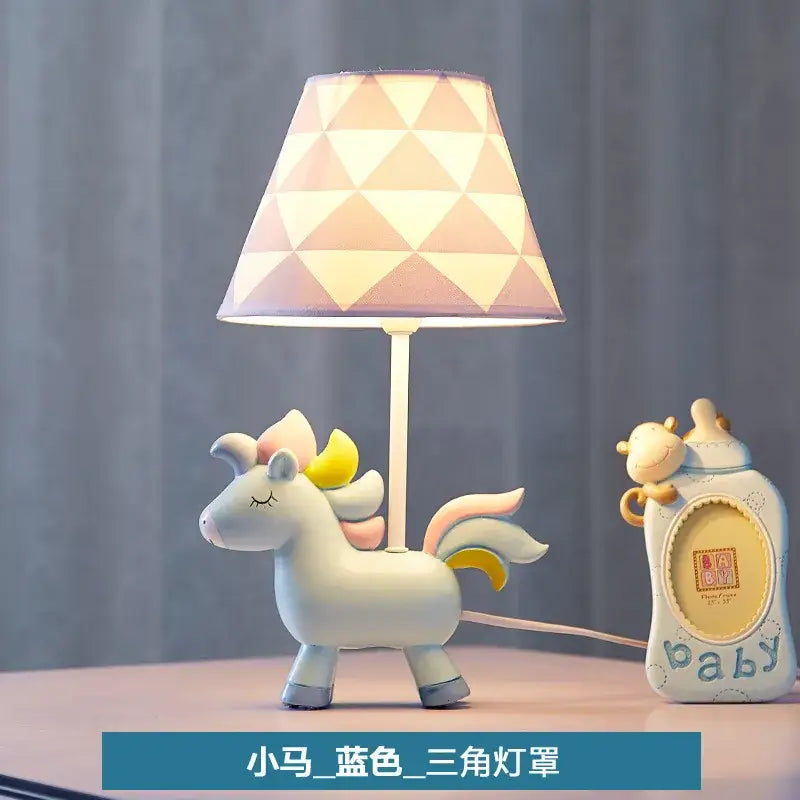 Whimsical white unicorn table lamp with pastel pink and cream geometric shade for children’s bedroom decor