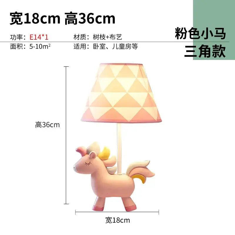 Pink unicorn table lamp with a blue geometric-patterned shade designed for children’s bedroom decor