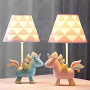 Two pastel pink and blue unicorn table lamps with geometric patterned shades for children’s bedroom decor