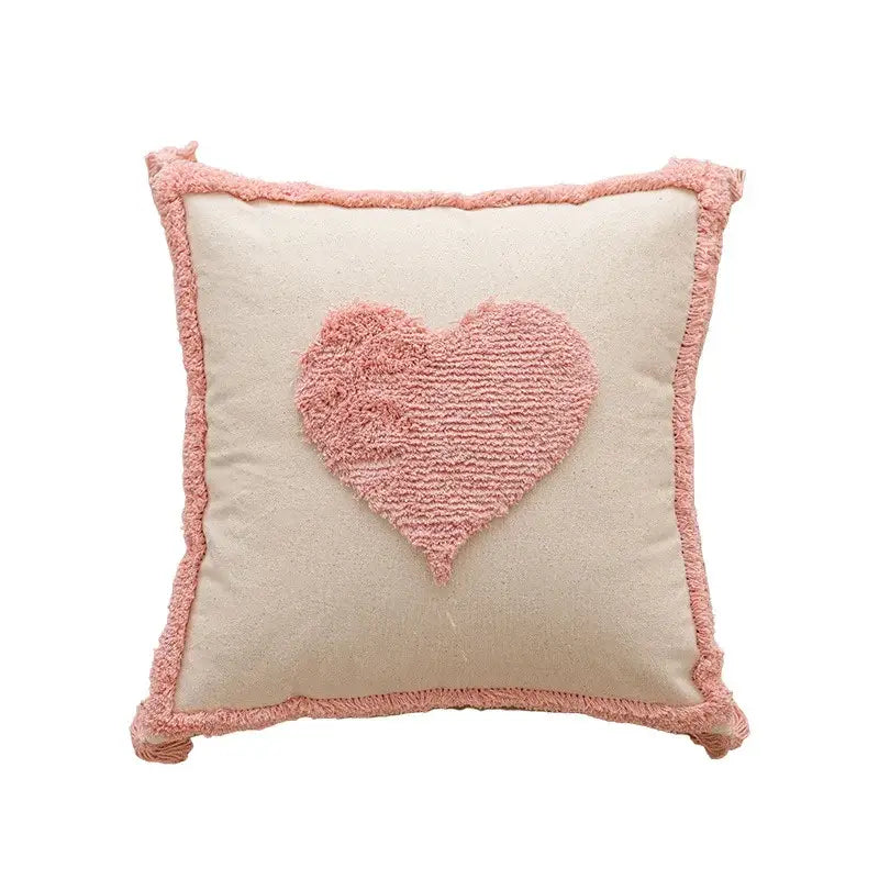 A cream cushion cover with a soft pink heart appliqué and frayed edges for decorbites geometric embroidered pillow covers