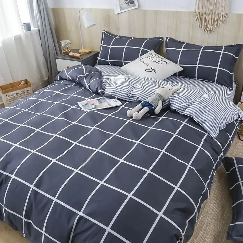 Navy blue and white grid-patterned quilt cover set with matching pillows designed for a geometric pink and white gingham bedroom