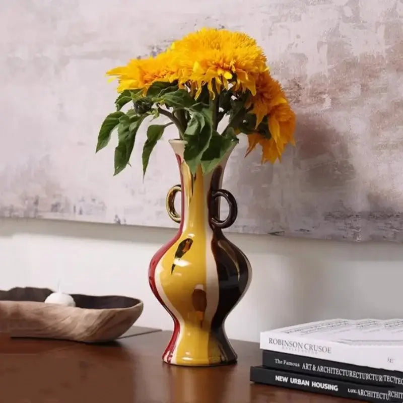 A vibrant geometric horse head ceramic vase with dual handles in bold red, yellow, and black for living room decor