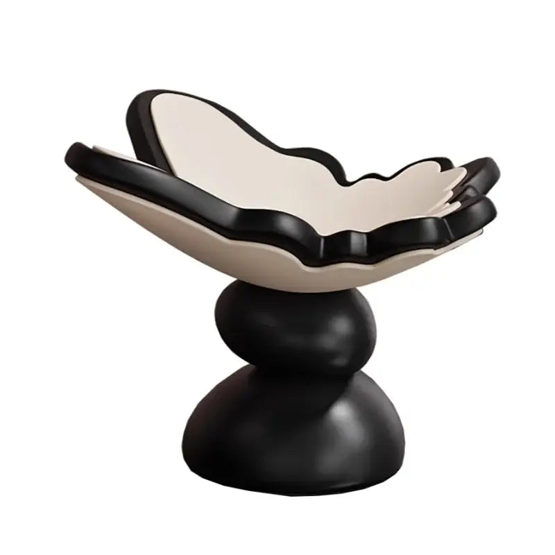 Black and cream ceramic flower bowl with layered petals on pedestal base for geometric resin tray dining room storage