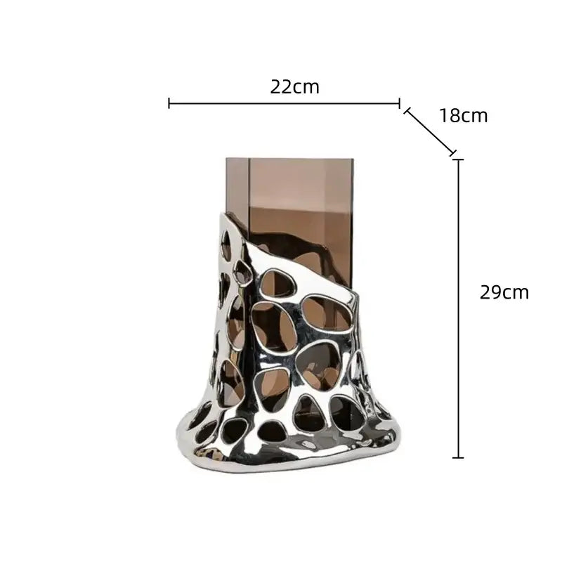 Geometric acrylic glass vase featuring a silver sculptural perforated design with amber glass insert for living room decor