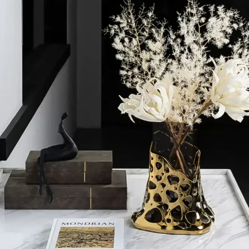 Gold and black ceramic vase with irregular cutouts paired with geometric acrylic glass vase for modern decorbites decor