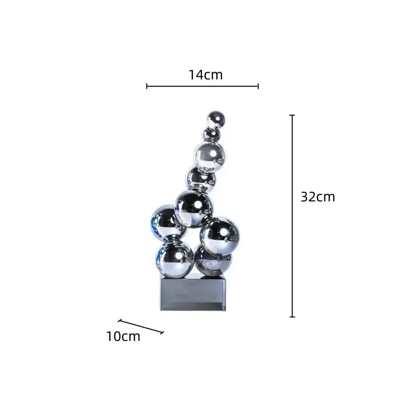 A sleek geometric crystal sculpture silver ball composed of stacked chrome spheres on a rectangular base for decor