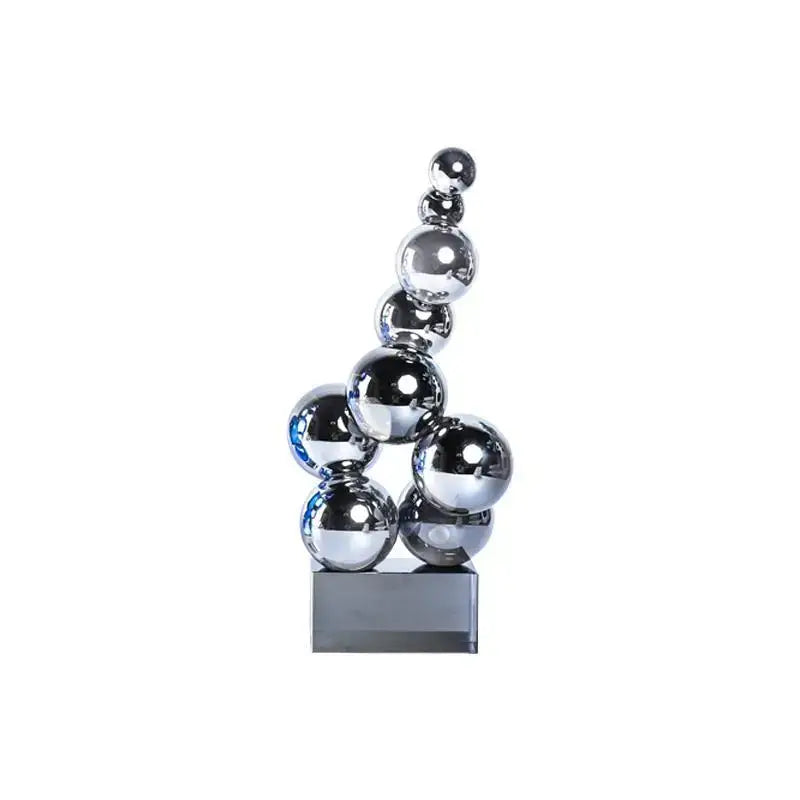 Shiny chrome spheres in a geometric crystal sculpture silver ball on a sleek black base for living room decor