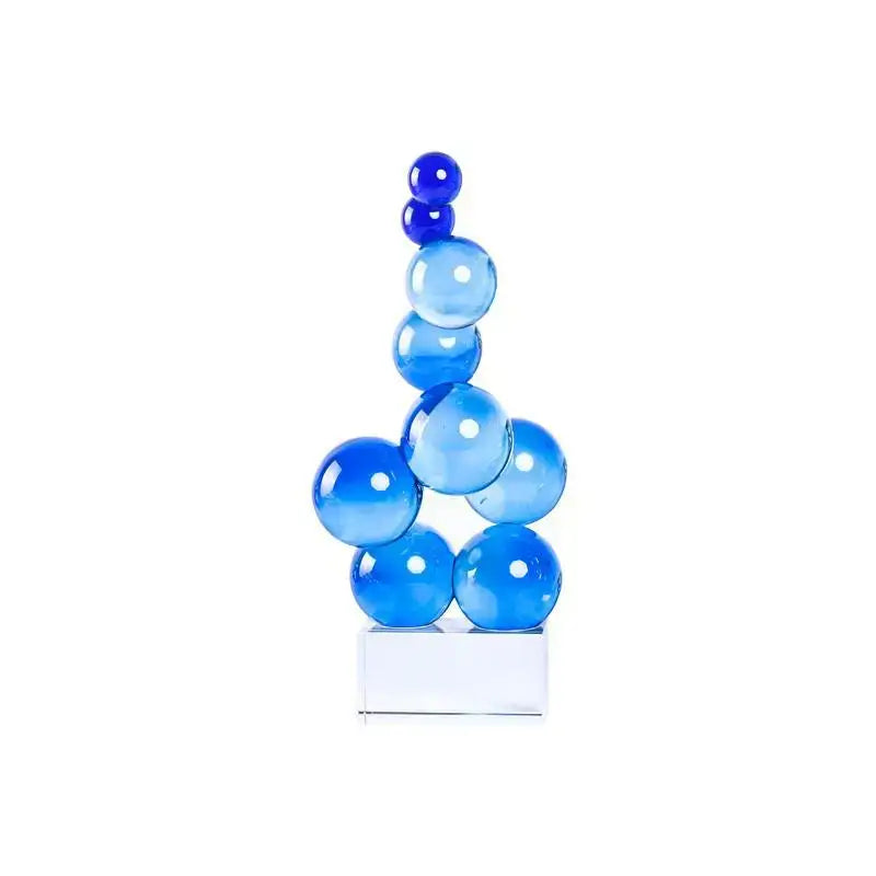 A geometric crystal sculpture silver ball in translucent blue glass with stacked spheres on a clear rectangular base