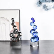 Geometric crystal sculpture featuring a stacked silver reflective and blue translucent crystal sculpture silver ball decor