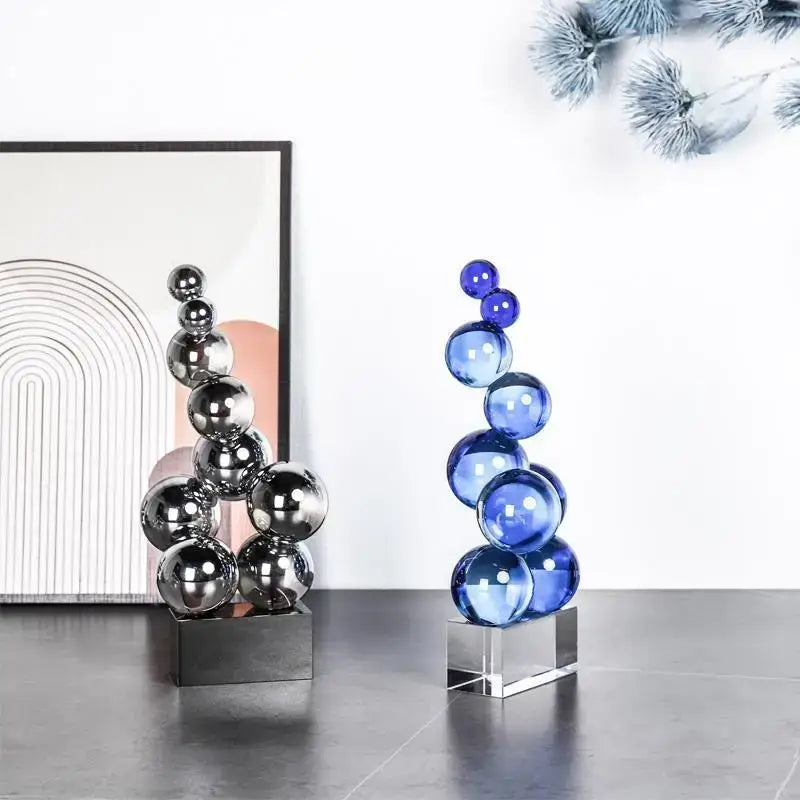 Geometric crystal sculpture featuring a stacked silver reflective and blue translucent crystal sculpture silver ball decor