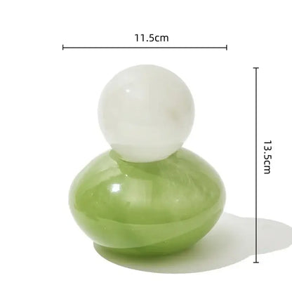 A smooth polished green and white geometric sphere glass vase with lid for bedroom desktop storage container