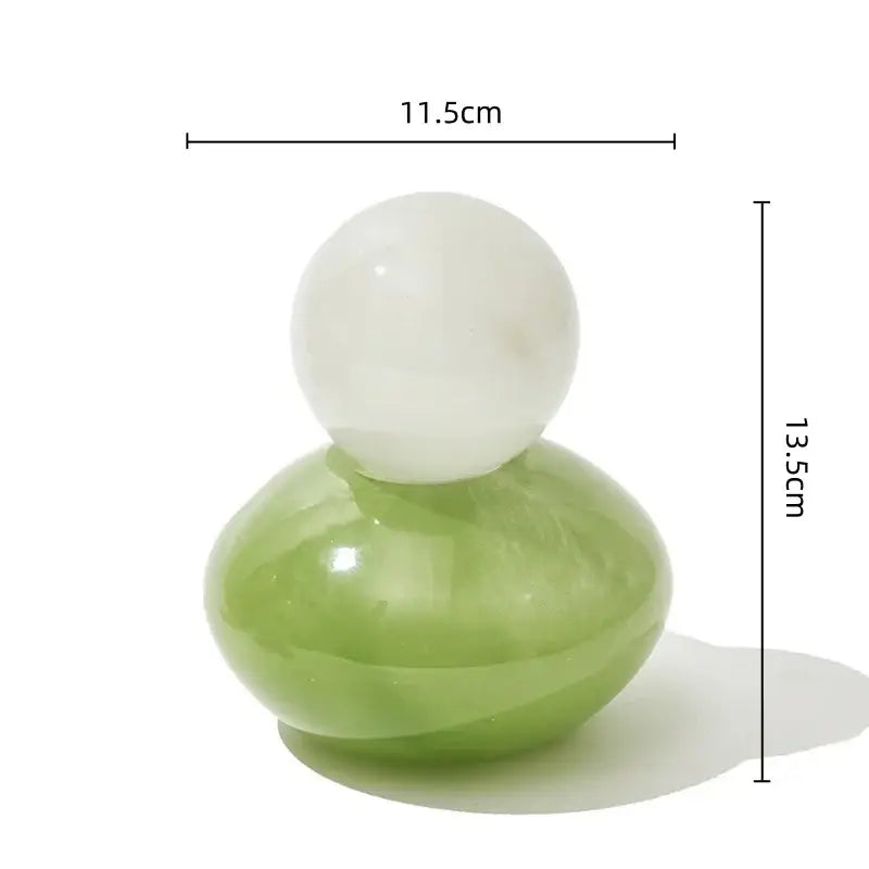 A smooth polished green and white geometric sphere glass vase with lid for bedroom desktop storage container