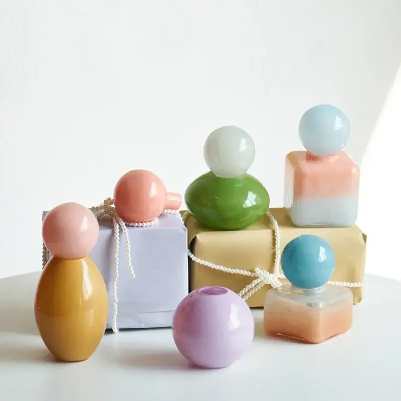 Pastel-colored geometric sphere glass vase with lid featuring spherical caps and gradient finishes for desktop storage