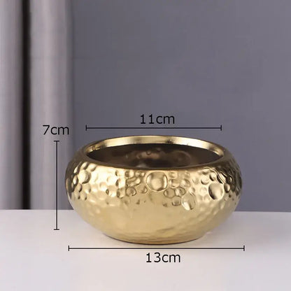 Gold-colored hammered metal bowl with textured surface complementing geometric stacked ceramic vase decorbites ceramic vase collection