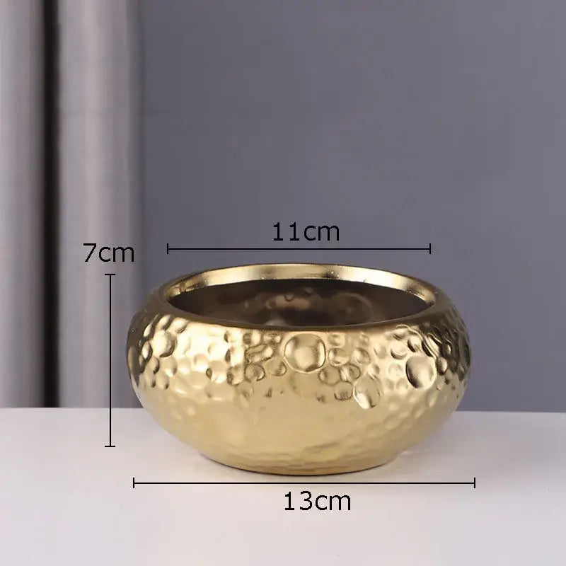 Gold-colored hammered metal bowl with textured surface complementing geometric stacked ceramic vase decorbites ceramic vase collection