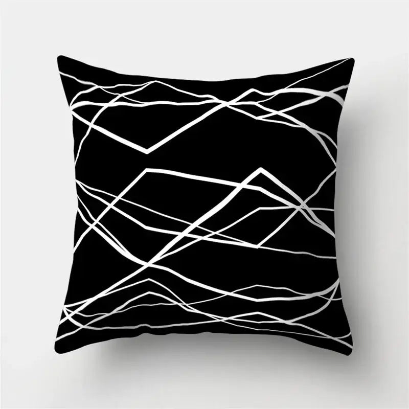 Black square pillow cover with white geometric star design for modern home decor by Decorbites