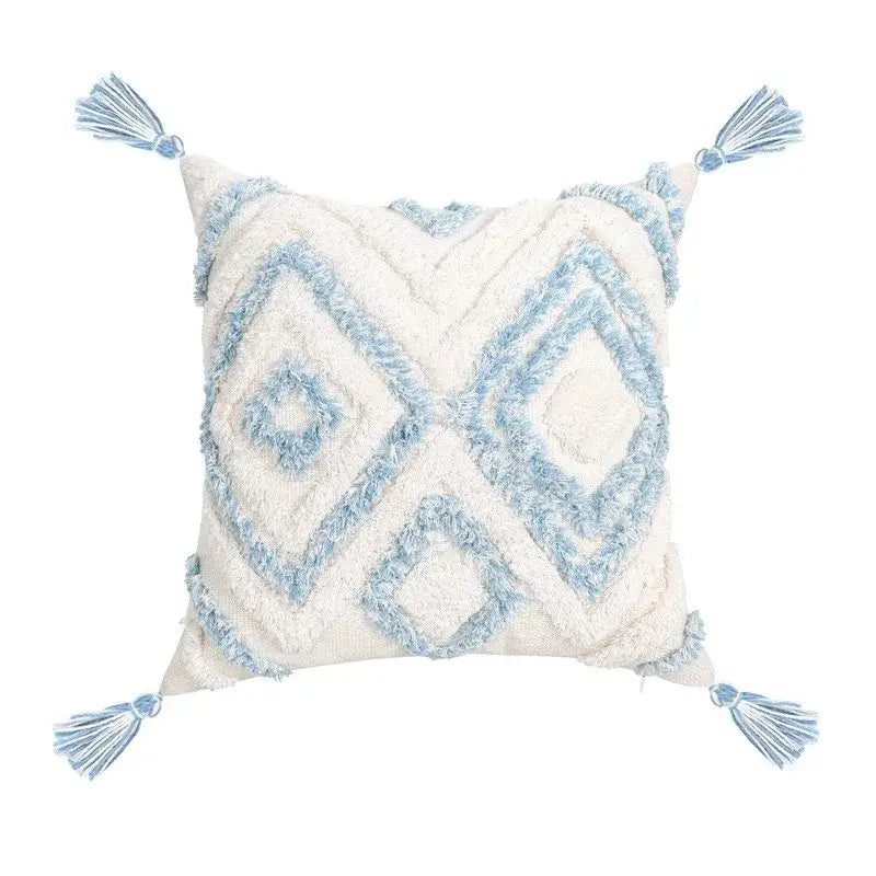 Cream-colored pillow cover with light blue geometric tassel tufted embroidery and matching corner tassels for living room use