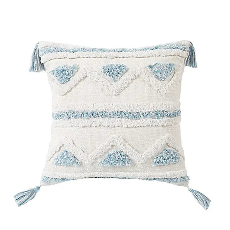 Cream-colored pillow covers with light blue geometric tassel tufted embroidery and matching tassels for living room decor