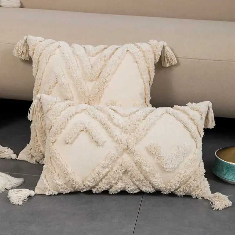 Cream-colored cushion cover with textured geometric tufted fringed embroidery and tassels for living room decorbites decor