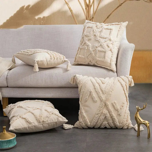 Cream-colored cushion cover with decorbites geometric tufted fringed texture and tassels for living room decor
