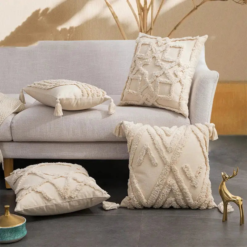 Cream-colored cushion cover with decorbites geometric tufted fringed texture and tassels for living room decor