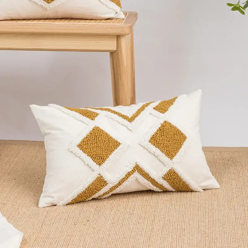 Cream-colored cushion cover with mustard geometric tufted plush pattern and white fringe accents for living room decorbites decor
