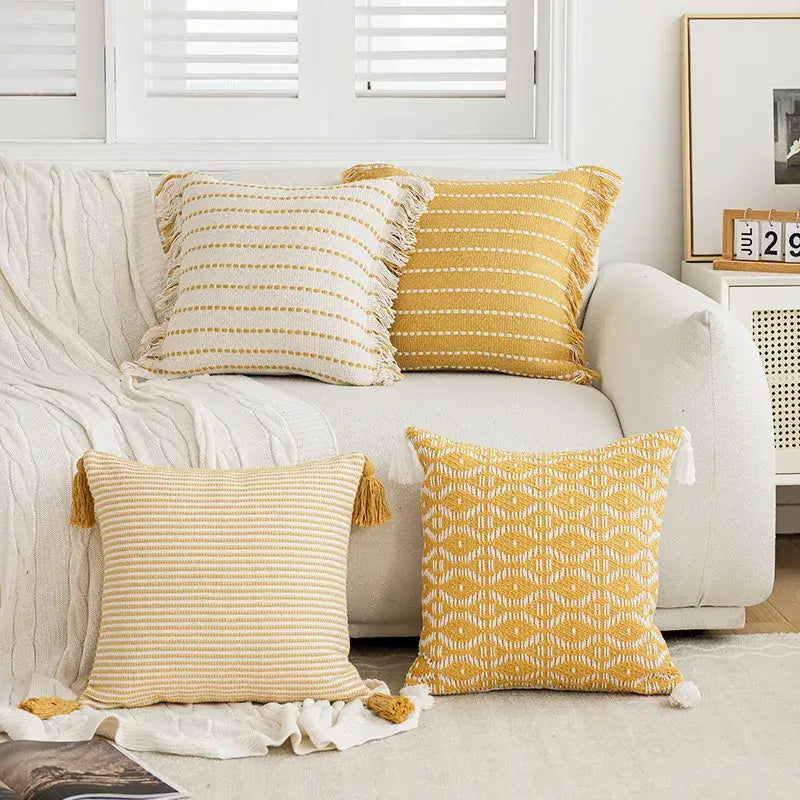 Yellow and white striped throw pillows with crochet tassels featuring decorbites geometric tufted cushion cover design