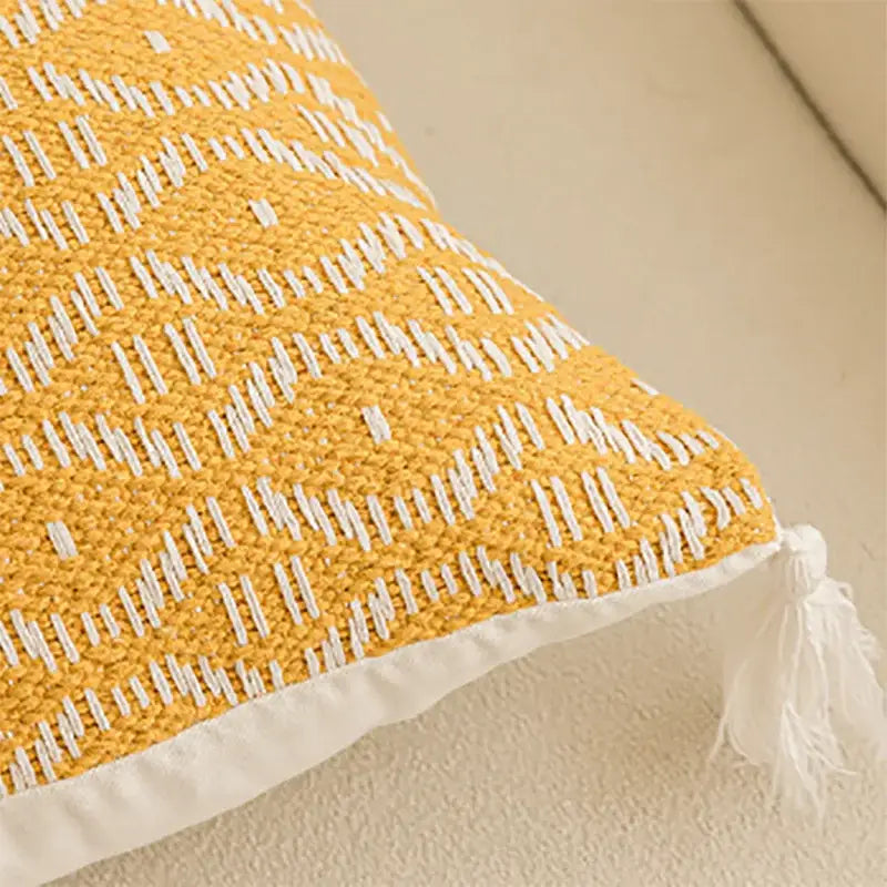 Yellow and white woven cushion cover with textured geometric tufted pattern and crochet tassels for living room decorbites decor