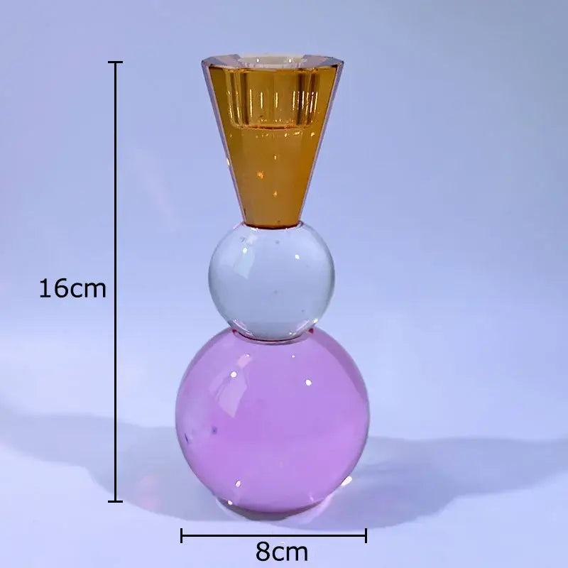 A modern three-tiered glass crystal candle holder with amber, translucent white, and lavender faceted design