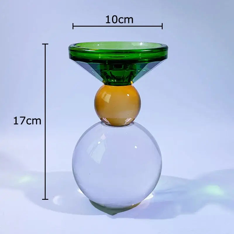 Translucent glass crystal candle holder with green faceted top and amber sphere for dining room decor