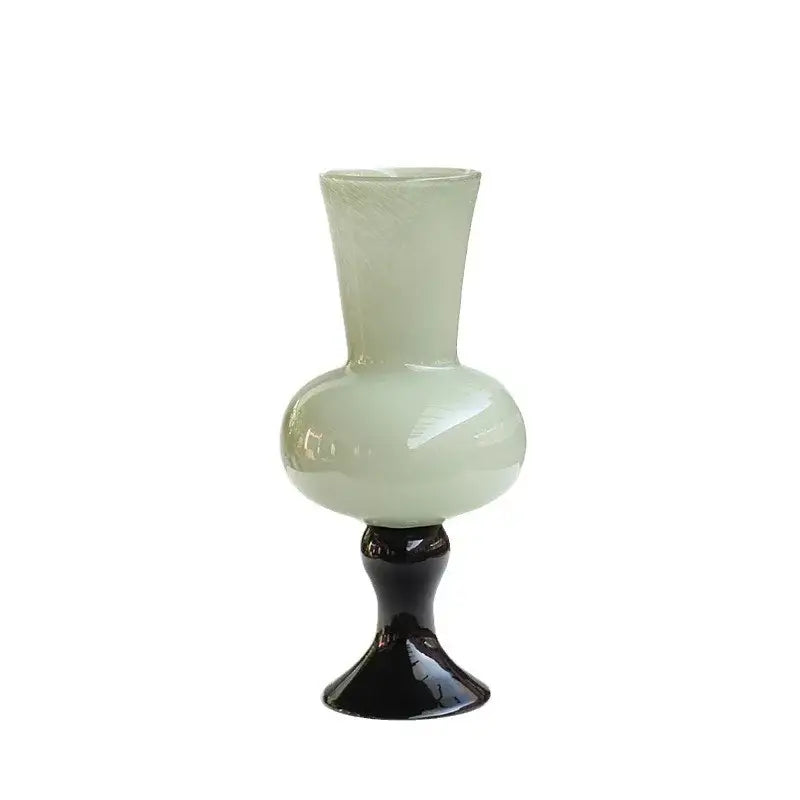 A translucent pale green geometric vintage glass vase with bulbous body on a black pedestal base for decorbites decor