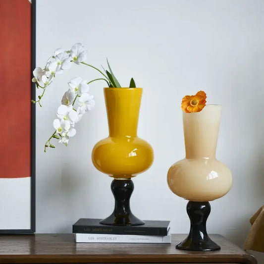 Two glossy bulbous vintage glass vases with black stems in mustard and cream for geometric vintage glass decorbites decor