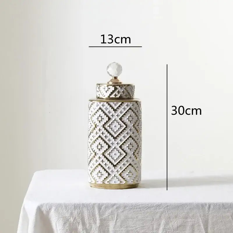 A 30cm ceramic decorative jar with white and golden relief geometric pattern and a crystal knob lid by decorbites geometric golden