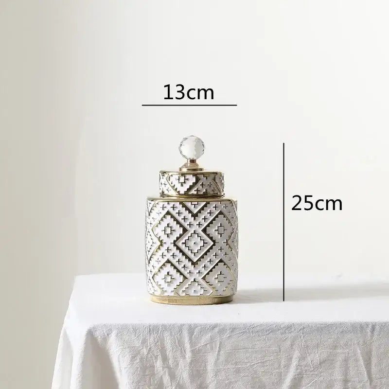 A white ceramic decorative jar with golden relief geometric pattern and crystal knob for kitchen canister decorbites geometric golden