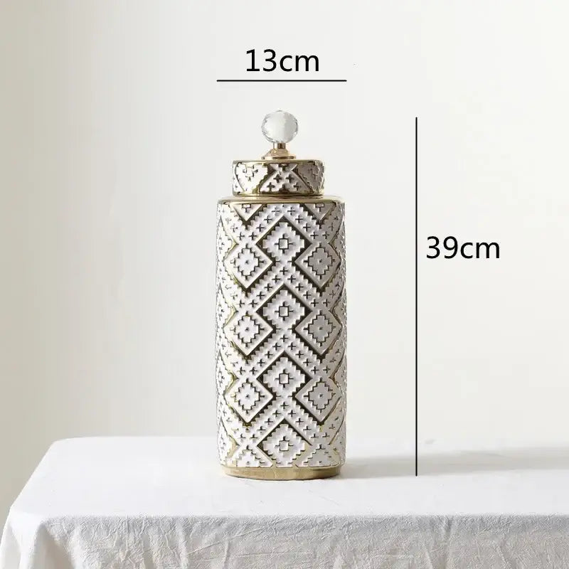 A tall 39cm ceramic decorative jar with white and golden relief geometric pattern and a crystal knob lid by decorbites geometric golden