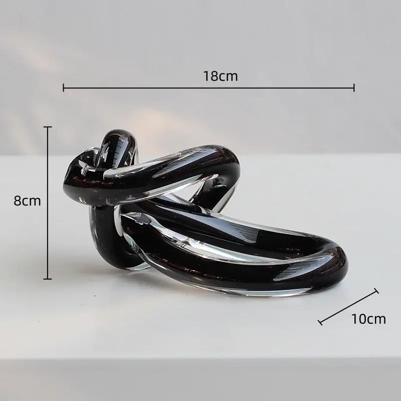 A sleek glossy black glass twine knot sculpture for home decor by decorbites geometric glass living room decor