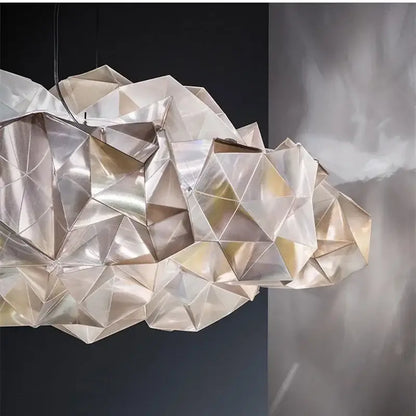 A modern geometric pendant light with faceted cloud-like design in silver and gold decorbites clouds white gold material