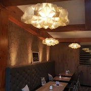 Geometric white gold pendant light with warm glowing illumination made of paper for decorbites clouds white decor