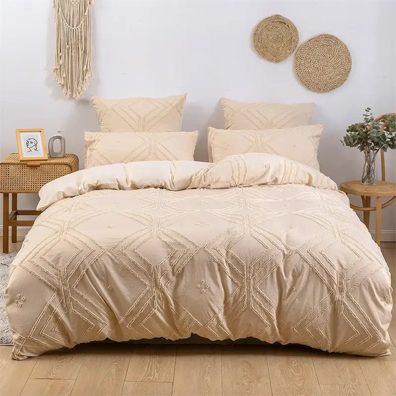 Beige quilted duvet cover with geometric embroidery pattern as part of a geometric white quilted duvet cover set